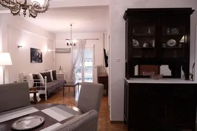 a living room with a table and a dining room at Koukaki Athens 2 bedrooms flat next to Acropolis in Athens