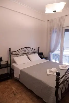 a bedroom with a large bed with a window at Koukaki Athens 2 bedrooms flat next to Acropolis in Athens