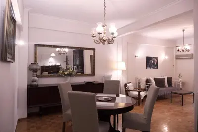 a living room with a table and a dining room at Koukaki Athens 2 bedrooms flat next to Acropolis in Athens
