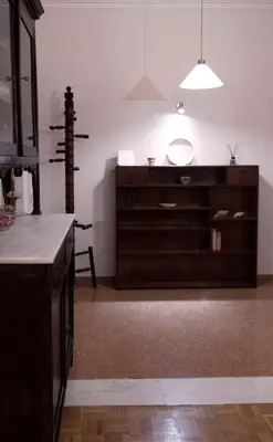 a kitchen with a wooden cabinet and a table at Koukaki Athens 2 bedrooms flat next to Acropolis in Athens