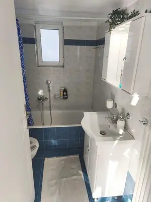 a bathroom with a sink and a tub and a toilet at Acropolis Sweet House 6 in Athens
