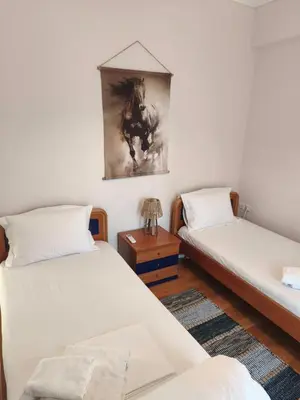 a room with two beds and a picture on the wall at Acropolis Sweet House 6 in Athens