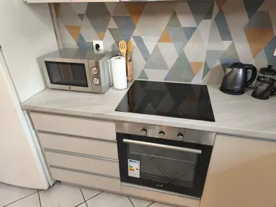 a kitchen with a stove and a microwave on a counter at Acropolis Sweet House 6 in Athens