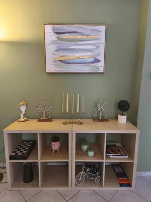a wooden cabinet with a painting on the wall at Acropolis Sweet House 6 in Athens