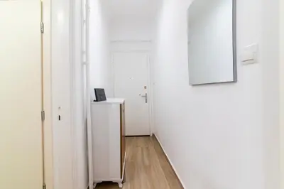 a hallway with two white doors and a picture on the wall at Stylish New Modern Residence - 270m to Metro - Central Athens in Athens