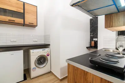 a kitchen with a washer and dryer on a counter at Stylish New Modern Residence - 270m to Metro - Central Athens in Athens