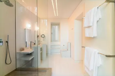 a bathroom with a shower and a sink and a mirror at Plaka Villa with Epic Acropolis Views in Athens