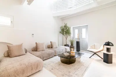 a white living room with a couch and a table at Plaka Villa with Epic Acropolis Views in Athens