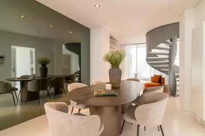 a dining room with a table and chairs and a staircase at Plaka Villa with Epic Acropolis Views in Athens