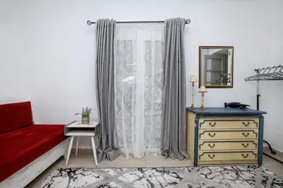 a bedroom with a bed and a dresser and a mirror at Green Dome Escape in Athens