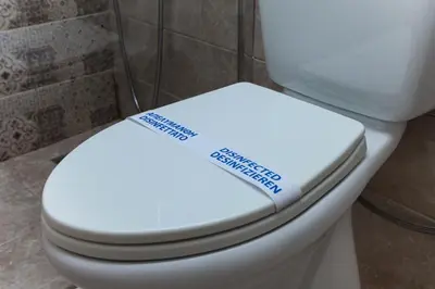 a white toilet with a sign on the seat at Green Dome Escape in Athens
