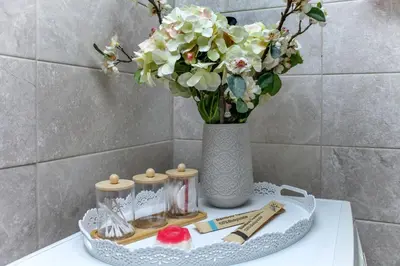a table with a vase with flowers in a bathroom at Green Dome Escape in Athens