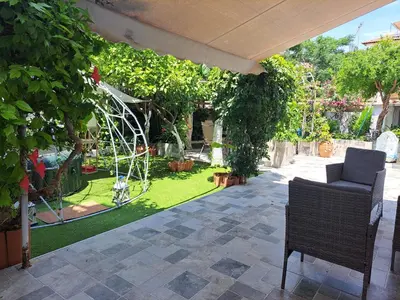 a patio with a garden with a playground at Green Dome Escape in Athens
