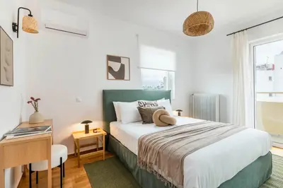 a bedroom with a bed and a desk and a window at Elevated 2BR Apartment in Chalandri by UPSTREET in Athens