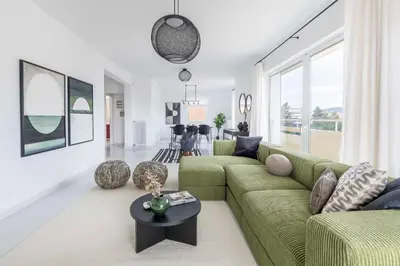 a living room with a green couch and a table at Elevated 2BR Apartment in Chalandri by UPSTREET in Athens
