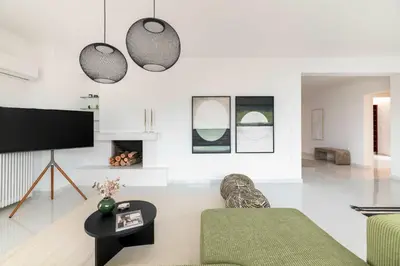 a living room with a couch and a tv at Elevated 2BR Apartment in Chalandri by UPSTREET in Athens