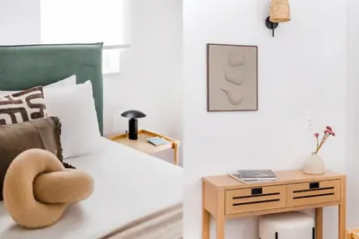 a bedroom with a bed with a nightstand next to a side table at Elevated 2BR Apartment in Chalandri by UPSTREET in Athens