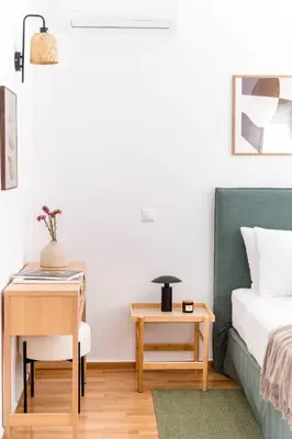 a bedroom with a bed and a desk and a table with a chair at Elevated 2BR Apartment in Chalandri by UPSTREET in Athens