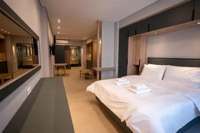 a bedroom with a large bed with two towels on it at Millennial Apartments Athens in Athens