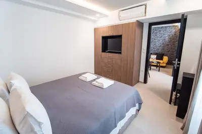 a bedroom with a bed with two towels on it at Millennial Apartments Athens in Athens