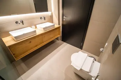 a bathroom with a sink and a toilet and a mirror at Millennial Apartments Athens in Athens