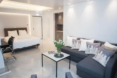 a living room with a couch and a bed at Millennial Apartments Athens in Athens