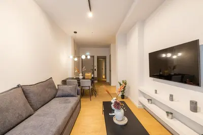 a living room with a couch and a table at Rooms151 Business Suite in the Center of Athens 1st floor-3 in Athens