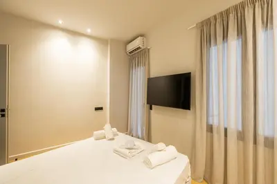 a hotel room with a bed and a television at Rooms151 Business Suite in the Center of Athens 1st floor-3 in Athens