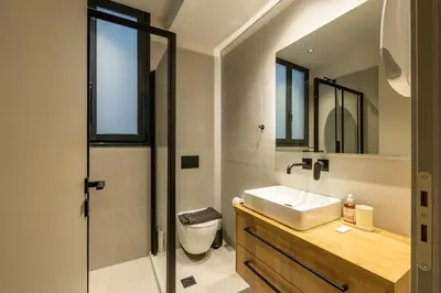 a bathroom with a sink and a toilet and a mirror at Rooms151 Business Suite in the Center of Athens 1st floor-3 in Athens