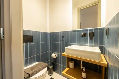 a blue tiled bathroom with a sink and a toilet at Rooms151 Business Suite in the Center of Athens 1st floor-3 in Athens