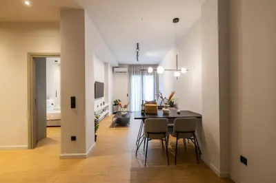 a dining room and living room with a table and chairs at Rooms151 Business Suite in the Center of Athens 1st floor-3 in Athens