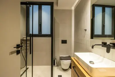 a bathroom with a shower and a toilet and a sink at Rooms151 Business Suite in the Center of Athens 1st floor-3 in Athens