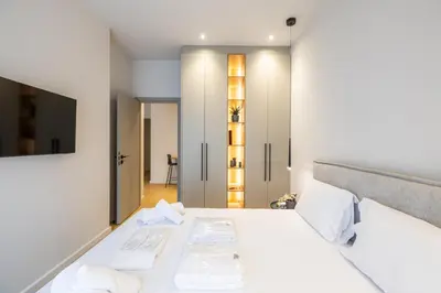 a bedroom with a bed with two white towels at Rooms151 Business Suite in the Center of Athens 1st floor-3 in Athens