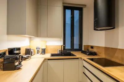 a kitchen with white cabinets and a sink at Rooms151 Business Suite in the Center of Athens 1st floor-3 in Athens
