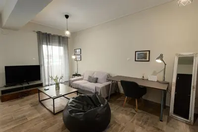 a living room with a couch and a table at Sunny Athenian Apartment in Athens