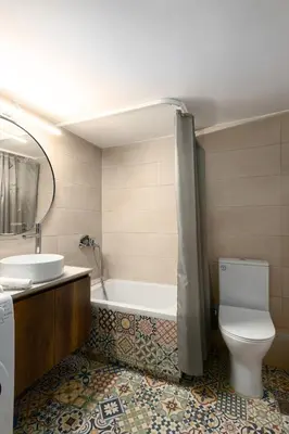 a bathroom with a tub and a toilet and a sink at Sunny Athenian Apartment in Athens