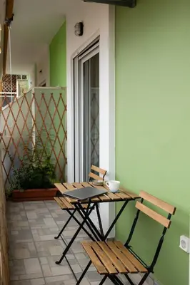 a table and two chairs sitting on a patio at Sunny Athenian Apartment in Athens
