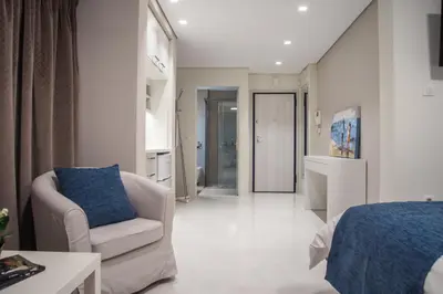 a living room with a couch and a chair at Millennial Apartments Voulis in Athens