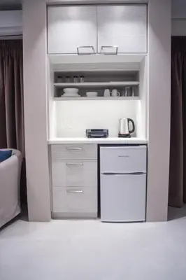 a white kitchen with a stove and a refrigerator at Millennial Apartments Voulis in Athens