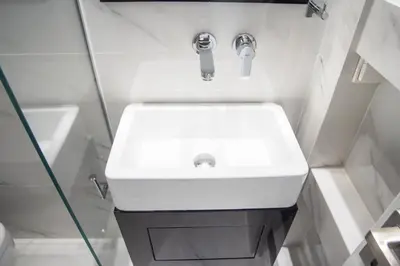 a bathroom with a white sink and a shower at Millennial Apartments Voulis in Athens