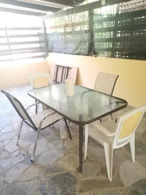 a glass table and chairs in a room at Andy's sweet house in Athens
