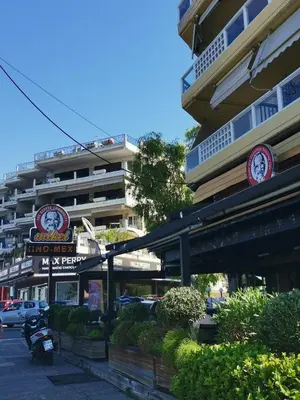 a building with a clock on the side of it at Andy's sweet house in Athens
