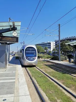 a silver train on the tracks at a train station at Andy's sweet house in Athens