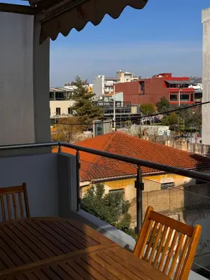 a balcony with a table and a view of a city at Βένερε in Athens