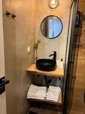 a bathroom with a sink and a mirror and towels at Athens Homey Haven in Athens