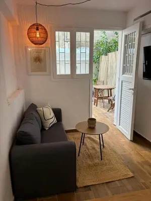 a living room with a couch and a table at Athens Homey Haven in Athens