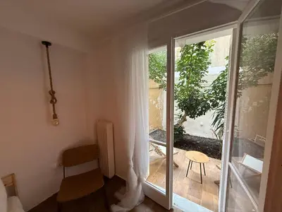 a room with a sliding glass door leading to a patio at Athens Homey Haven in Athens