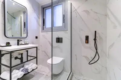 a bathroom with a shower and a toilet and a sink at ABOV Acropolis in Athens