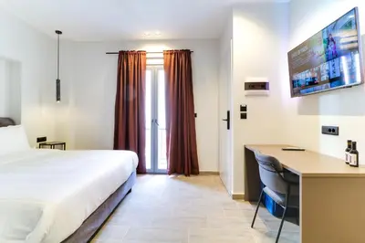 a hotel room with a bed and a desk at ABOV Acropolis in Athens