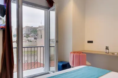 a room with a bed and a window with a view at ABOV Acropolis in Athens